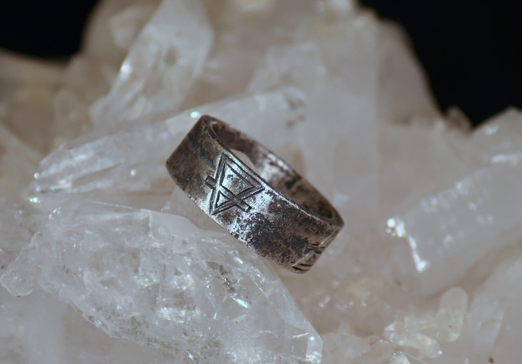 Engraved silver alchemy ring on crystal